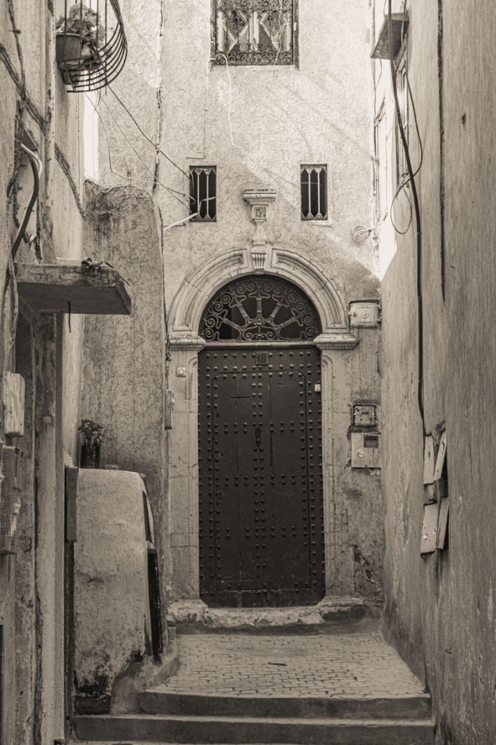 Carved door in alleyway in Rabat