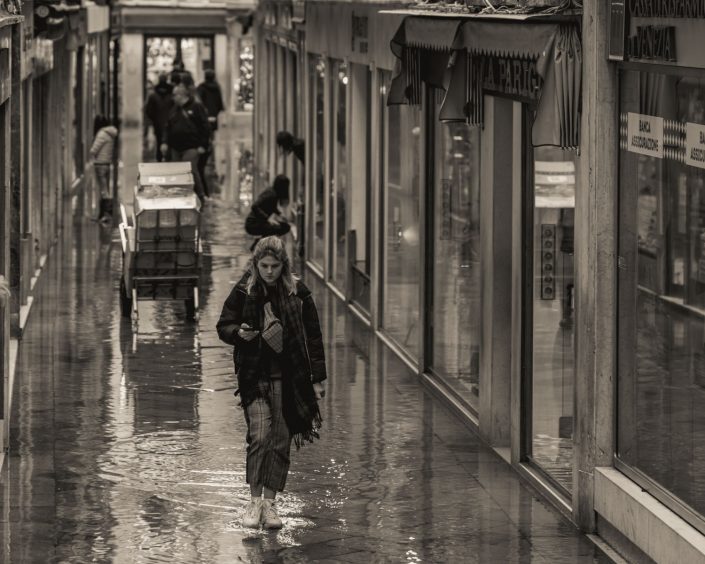 A woman walking through a flooded mall