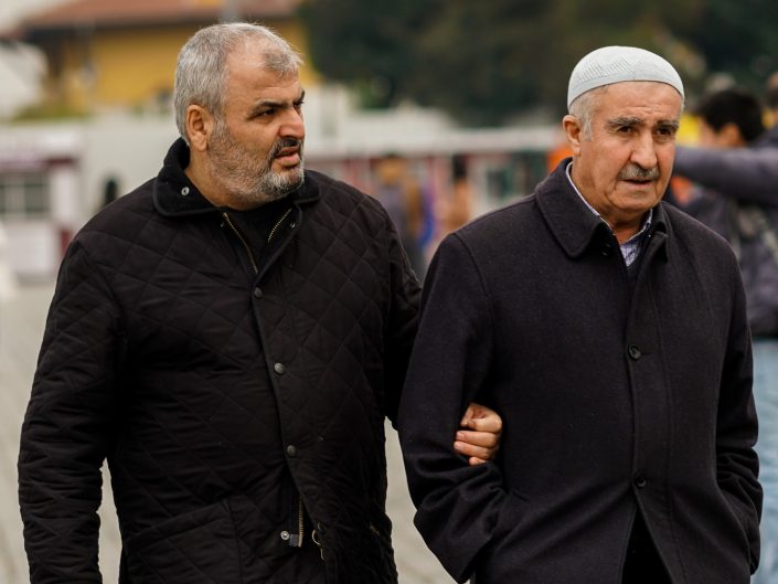 Turkish father and son arm in arm in Istanbul