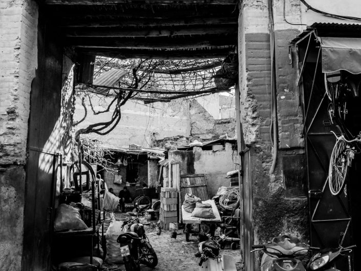 Alley View of an old car repair shop, men sitting