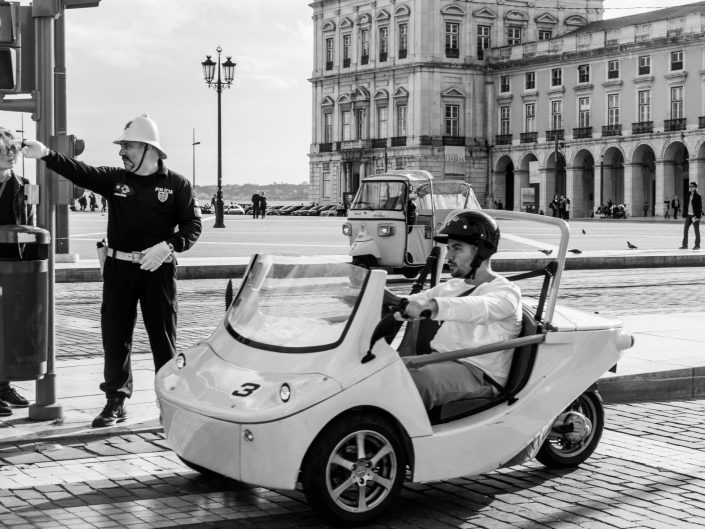 Lisbon Policeman giving directions, Miniature car bring driver by man