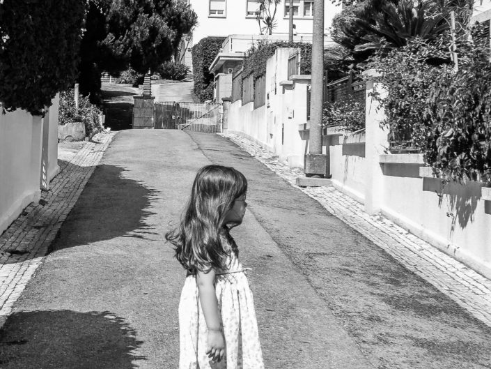 Little girl standing in a Lisbon street