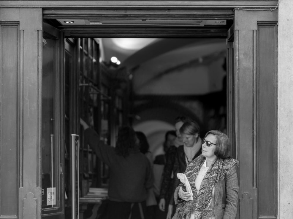 Woman standing at the door of a bookshop, Lisbon