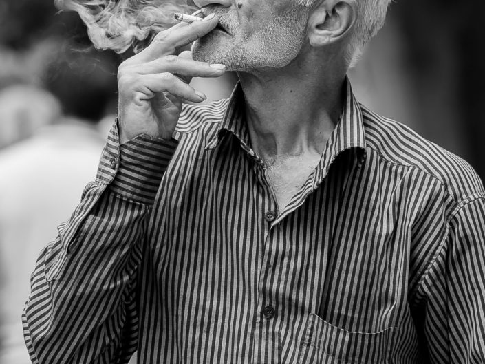 Man smoking in park, Iran