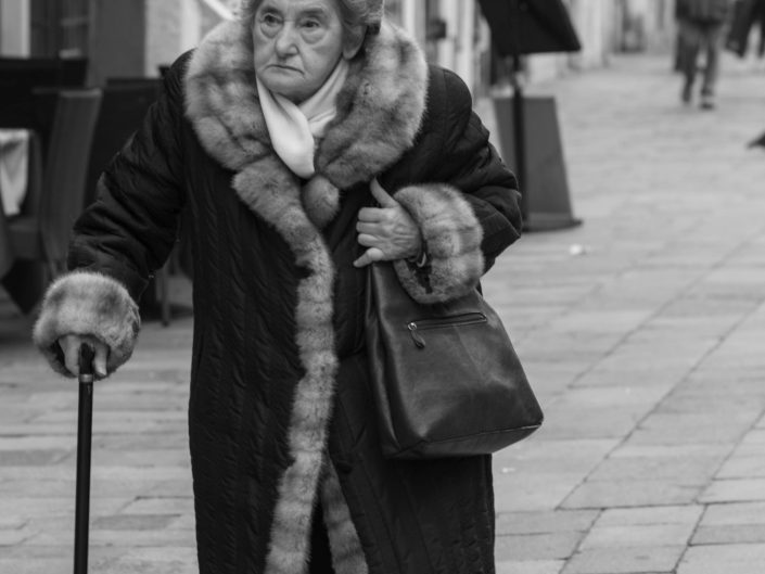 Venice old woman walking in the street