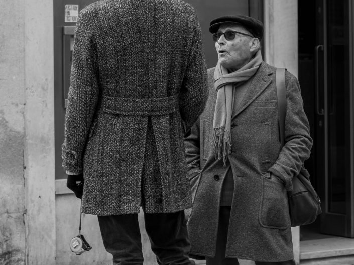 A short man talking to a very tall person in Venice
