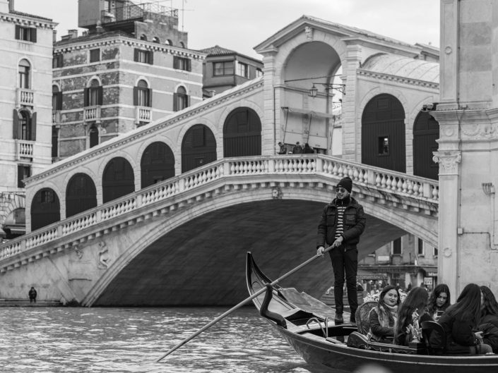 Venitian gondolier wearing sunglasses and hat