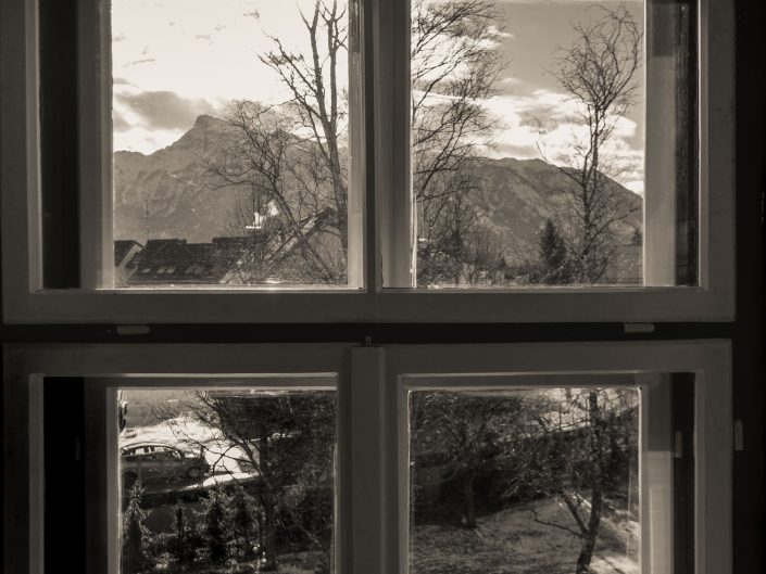 Looking Through a window at a mountain landscape