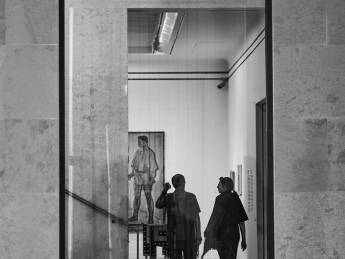 Through the window two people at the museum