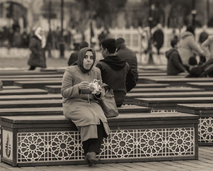 Woman eating on a bench